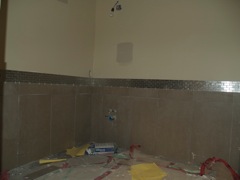 tile work continues in bathroom
