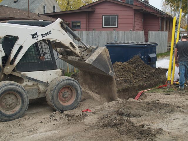 filling in on top of buried conduit